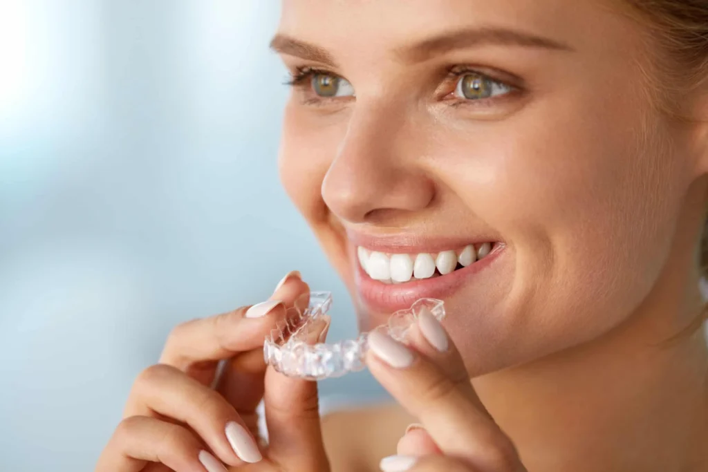 Woman holding a tooth aligner